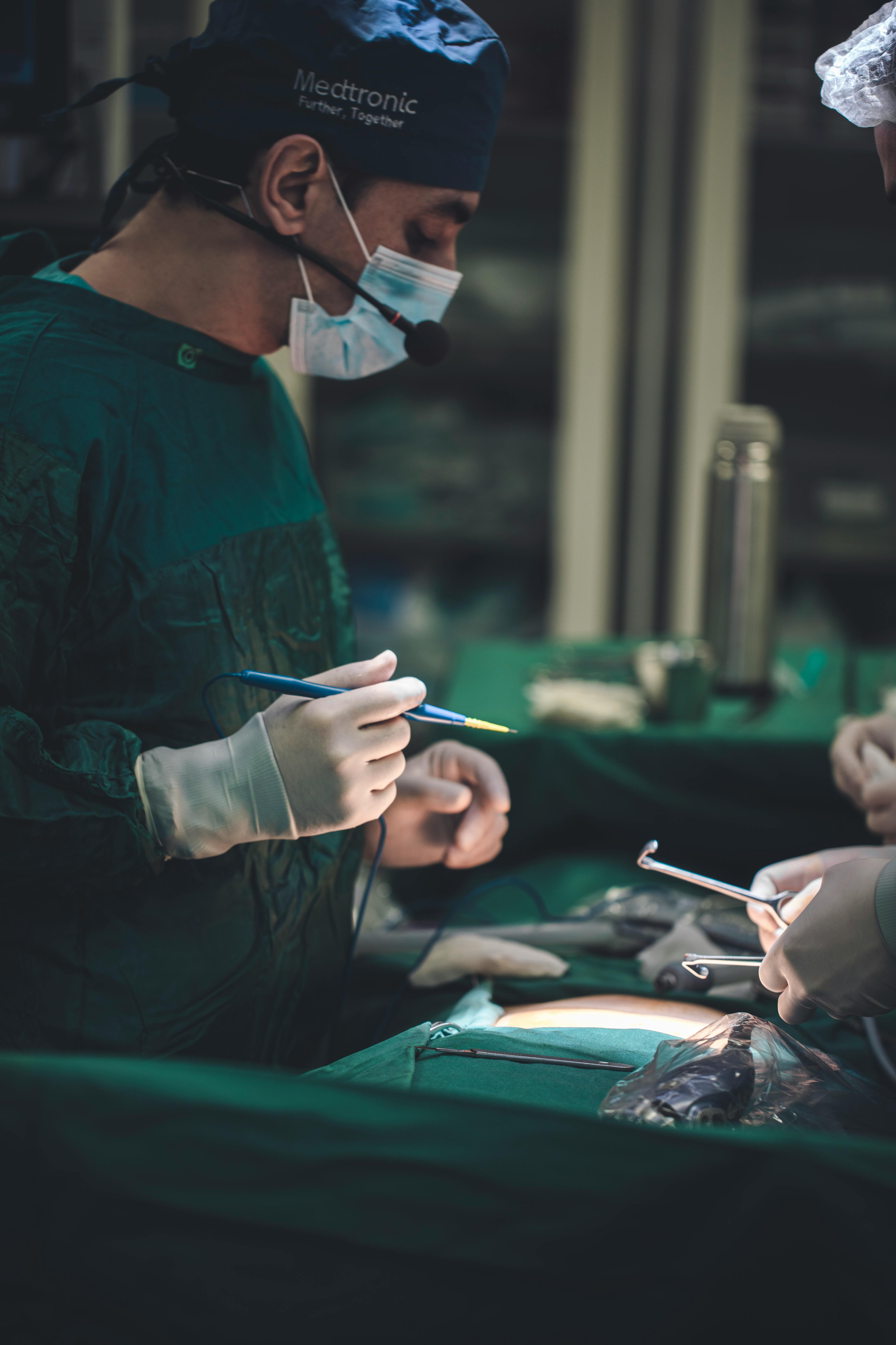 Surgeon operating in theatre